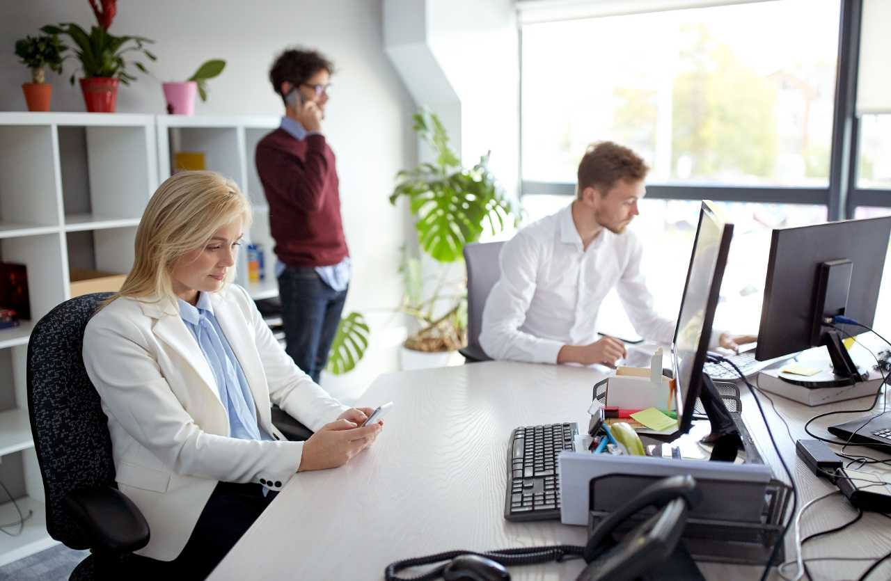 business team with smartphones and computers at office